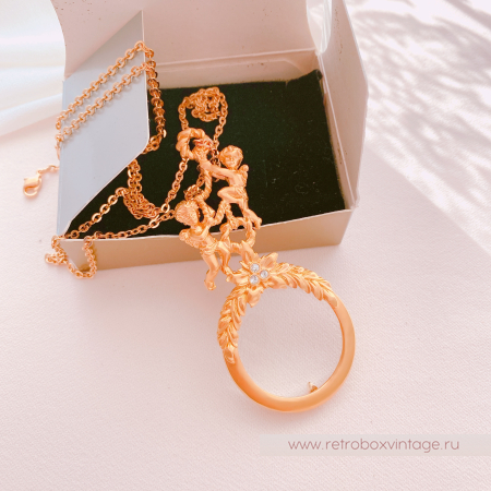 AVON Ожерелье-лорнет с лупой "Два ангелочка" 1997 г.